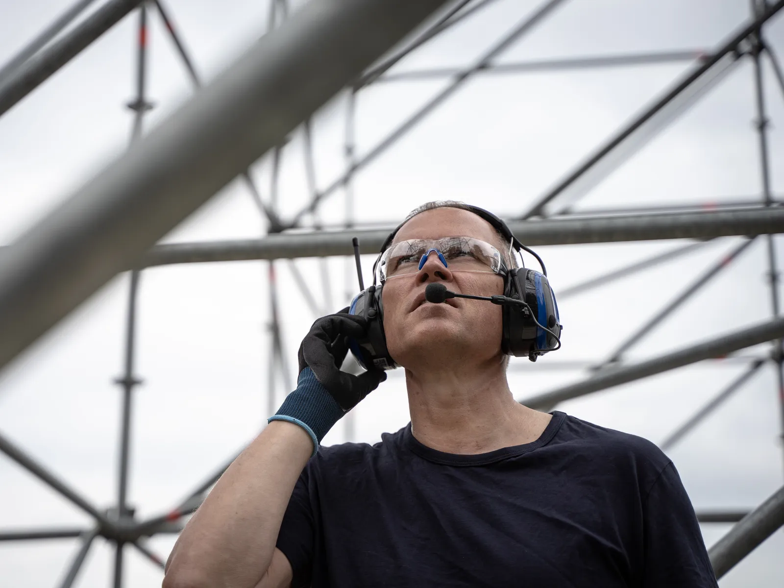 Construction worker on site in prescription safety glasses and hearing protection