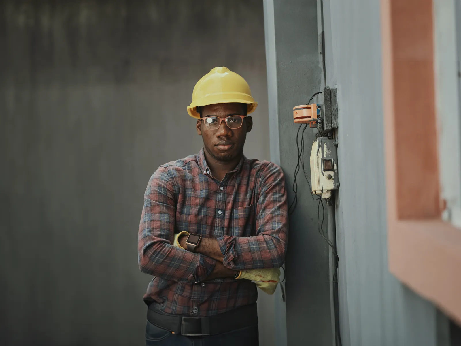 Utility electrician in a hard hat and prescription safety glasses