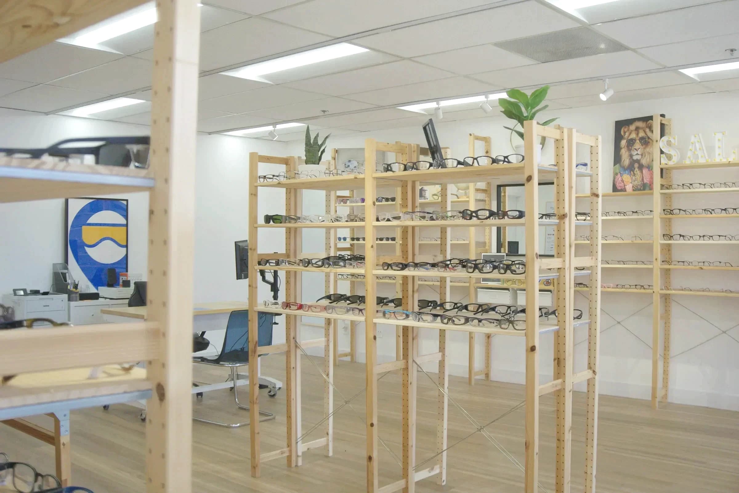 Frame racks in the Miramar showroom with the fitting desk beyond